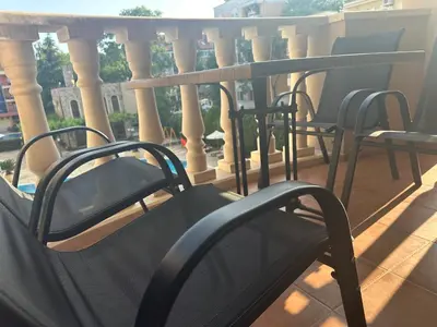 a row of chairs on a balcony with columns at Kalia A7 Sunny Beach in Sunny Beach