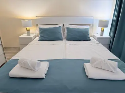 a bedroom with a large bed with two pillows at ViolaSuite in Varna South Bay by RV Apartments in Varna City