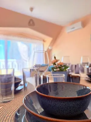a bowl on top of a table with glasses at ViolaSuite in Varna South Bay by RV Apartments in Varna City