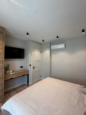 a bedroom with a bed and a tv on the wall at VIP Anvers Villa 50 in Elenite