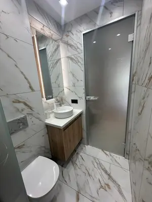 a bathroom with a shower and a toilet and a sink at VIP Anvers Villa 50 in Elenite