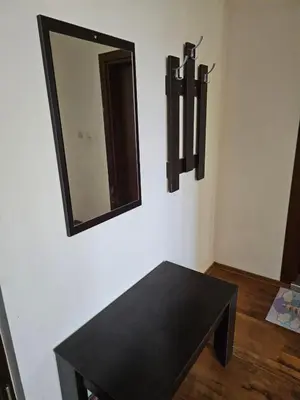 a black table and a mirror on a wall at Двокімнатна квартира у Panorama Bay 2 в Святому Власі Болгарія in Sveti Vlas