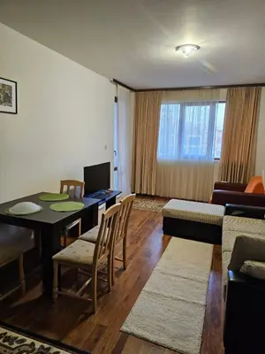 a living room with a table and a couch at Двокімнатна квартира у Panorama Bay 2 в Святому Власі Болгарія in Sveti Vlas