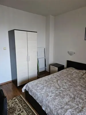 a bedroom with a bed and a cabinet and a rug at Двокімнатна квартира у Panorama Bay 2 в Святому Власі Болгарія in Sveti Vlas