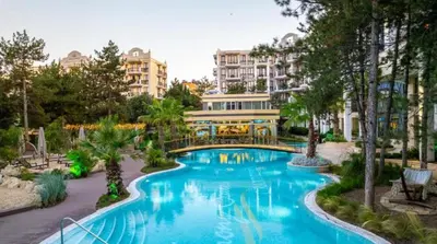 a swimming pool in a resort with trees and buildings at Harmony Suites Grand Resort 16 in Sunny Beach