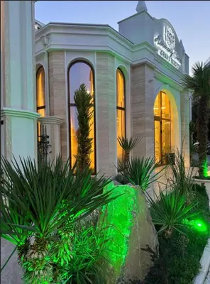 a house with green lights in front of it at Harmony Suites Grand Resort 16 in Sunny Beach