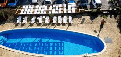 an overhead view of a large blue swimming pool with lounge chairs at Квартира студія у Panorama Bay 2 in Sveti Vlas