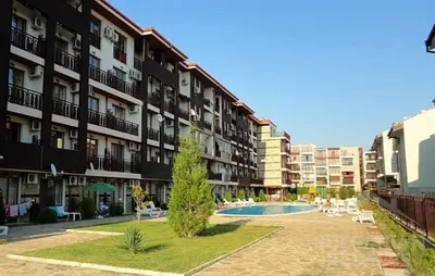 a large apartment building with a swimming pool in front of it at Квартира студія у Panorama Bay 2 in Sveti Vlas