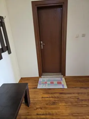 a door with a mat in front of it on a wooden floor at Квартира студія у Panorama Bay 2 in Sveti Vlas