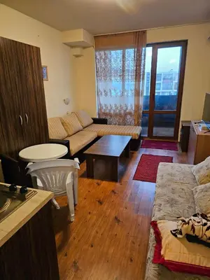 a living room with a couch and a table at Квартира студія у Panorama Bay 2 in Sveti Vlas