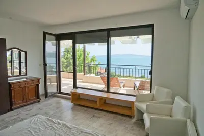a living room with a view of the ocean at Six bedroom luxury villa with private pool in quiet residential area near beaches in Sozopol