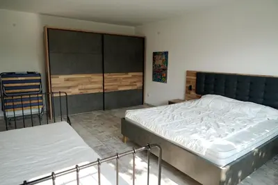 a bedroom with two beds and a chair at Six bedroom luxury villa with private pool in quiet residential area near beaches in Sozopol