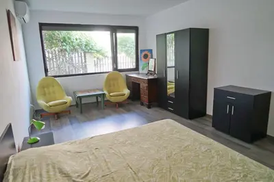 a bedroom with two chairs and a bed and a desk at Six bedroom luxury villa with private pool in quiet residential area near beaches in Sozopol