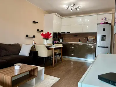a living room and kitchen with a couch and a table at Urban Nest Varna - Near Center and Bus Station in Varna City