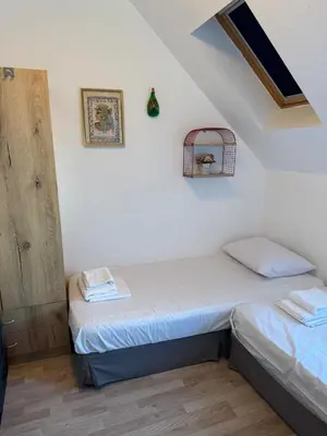 two twin beds in a room with white walls at Harbour Top-View Terrace 2-BDR Central Apartment in Varna City