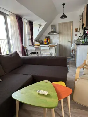 a living room with a couch and a table at Harbour Top-View Terrace 2-BDR Central Apartment in Varna City