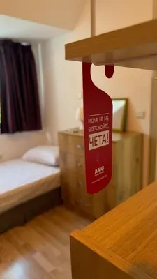 a room with a bed and a red sign on a shelf at Harbour Top-View Terrace 2-BDR Central Apartment in Varna City