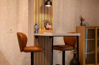 a bar with two stools in a room at Spirit apartment in Burgas City