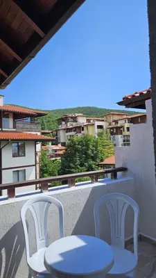 two white chairs and a table on a balcony at PSB Apartments in Etara 2 & 3 Complex Sveti Vlas in Sveti Vlas