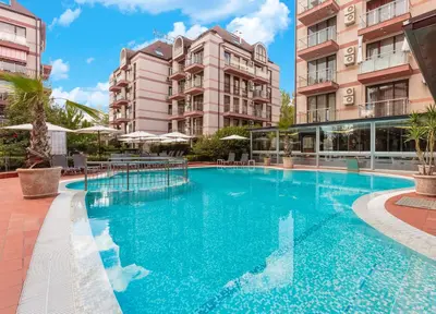 a large swimming pool in front of buildings at All-inclusive Holiday Apartments in Tarsis Hotel & Aquapark in Sunny Beach