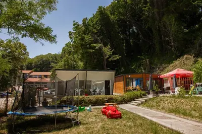 a home with a tent and a trampoline in the yard at Къмпинг Албатрос in Varna City