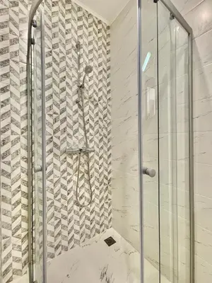 a bathroom with a shower with a glass door at Tryavna Beach - Private apartment - BSR - 4 in Sveti Vlas