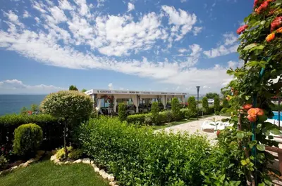 a view of a building with the ocean in the background at Tryavna Beach - Private apartment - BSR - 4 in Sveti Vlas