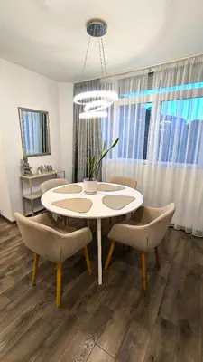 a dining room with a white table and chairs at Aperto Sozopoli Apartment in Sozopol