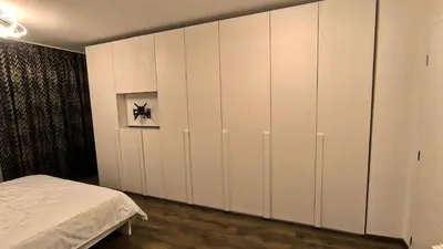 a bedroom with white cabinets and a bed at Aperto Sozopoli Apartment in Sozopol