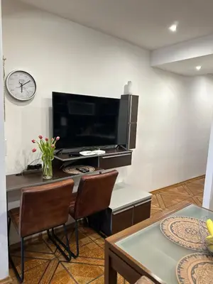 a living room with a television and a table and chairs at Zornitsa View in Burgas City