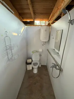 a small bathroom with a toilet and a sink at Каравана Мир in Chernomorets