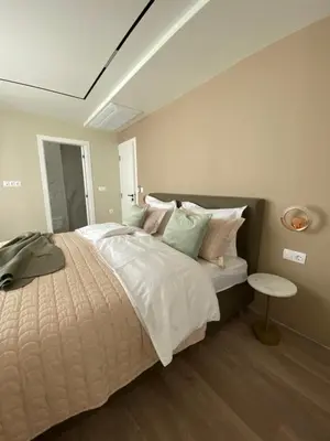 a bedroom with a large bed and a table at Luxurious house Sarafovo beach in Burgas City