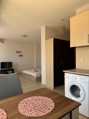a kitchen with a washing machine in a room at Студиа Осака in Sunny Beach