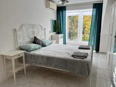 a bedroom with a large bed and a window at Burgas Center in Burgas City