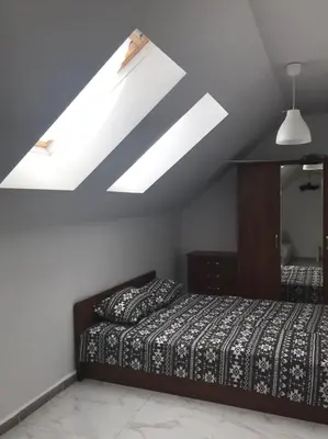 a bedroom with a bed and a skylight at Burgas Center in Burgas City