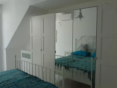 a bedroom with a mirror with a bed in it at Burgas Center in Burgas City
