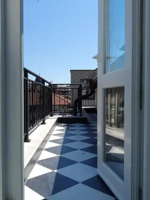 an open door to a balcony with a checkered floor at Burgas Center in Burgas City