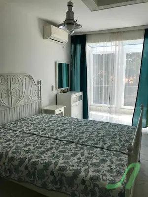 a bedroom with a large bed and a window at Burgas Center in Burgas City