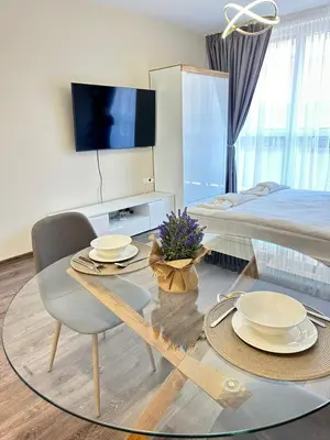 a living room with a table and a bed at Chantrer in Burgas City