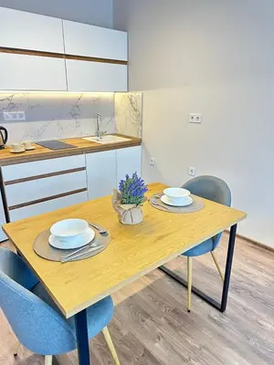 a kitchen with a wooden table with two plates on it at Chantrer in Burgas City
