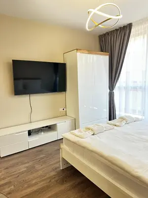a bedroom with a bed and a flat screen tv at Chantrer in Burgas City