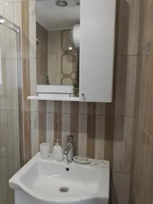 a bathroom with a white sink and a mirror at Paradiso Aparthotel, Studio 106 in Nesebar