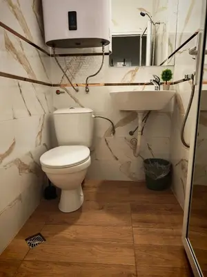 a bathroom with a toilet and a sink at Chance Sarafovo in Burgas City