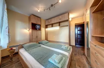 a bedroom with a large bed with blue pillows at Funny-Gunny Room to The Sea Garden in Burgas City