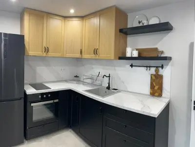 a kitchen with a black refrigerator and a sink at Magnoliya residence in Burgas City