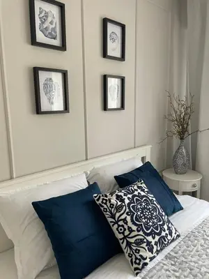 a bedroom with a bed with blue and white pillows at Magnoliya residence in Burgas City