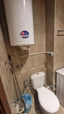 a bathroom with a toilet and a water tank at MitProt Panorama Bay 2 Studio 67 in Sveti Vlas