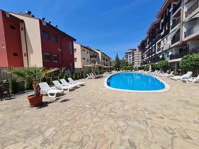 a swimming pool in the middle of a courtyard with lounge chairs at MitProt Panorama Bay 2 Studio 67 in Sveti Vlas