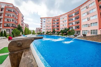 a swimming pool with a water fountain in front of buildings at Amartmán přímo u moře - Elenite in Sveti Vlas