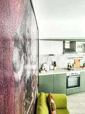 a living room with a couch and a kitchen at The Puzzle in Varna City